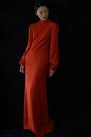Woman wearing a red dress against a black background