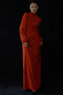 Woman wearing a red dress against a black background