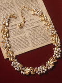 Gold necklace with pearls on a vintage book page