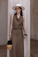 Elegant summer dress in earthy brown tone paired with minimal accessories and neutral backdrop