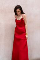A minimalist 100% linen slip dress with a handcrafted rose detail on the bust and a low open back, designed for summer vacations, weddings, and elegant evening occasions — Last Sunset Rosette Linen Slip Dress available in soft blush pink and deep crimson red.