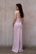 A minimalist 100% linen slip dress with a handcrafted rose detail on the bust and a low open back, designed for summer vacations, weddings, and elegant evening occasions — Last Sunset Rosette Linen Slip Dress available in soft blush pink and deep crimson red.