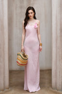 A minimalist 100% linen slip dress with a handcrafted rose detail on the bust and a low open back, designed for summer vacations, weddings, and elegant evening occasions — Last Sunset Rosette Linen Slip Dress available in soft blush pink and deep crimson red.
