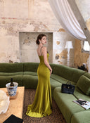 Chartreuse satin maxi dress, side view in living-room setting
