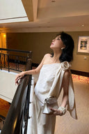 Close-up of the VOGSION Élan Quiet Luxury Linen Set showcasing premium textured linen fabric, sculptural floral shoulder detail, elegant one-shoulder draping, and refined craftsmanship inspired by quiet luxury fashion.
