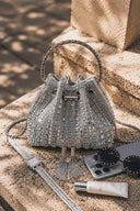 Silver crystal embellished VS Beaded Bucket Bag outdoor luxury product photography with sunglasses and watch
