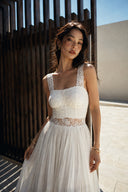 Vogsion Amber Light Lace Spliced Open Back Tie Strap Maxi Dress front close-up featuring delicate floral lace bodice, sheer lace waist panel, flowing ivory maxi skirt, elegant wedding guest dress for women, romantic bridal shower dress, garden wedding outfit, petite-friendly lace maxi dress.