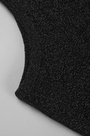 Close-up of VOGSION Noire Rosalie Glitter Rose Mermaid Maxi Dress textured knit fabric with a fine glittery or metallic flecked sheen, folded over on a light gray background.