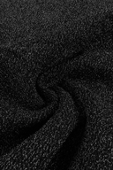 A close-up of a VOGSION Noire Rosalie Glitter Rose Mermaid Maxi Dress textured fabric with a fine glittery or speckled sheen, shown with soft folds.