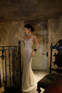 Side profile of the Vogsion Nocturne Sculpted Sequin Maxi Gown with shimmering champagne sequins, plunging neckline and sculpted mermaid silhouette. Luxury evening dress for black tie events, formal occasions, galas and cocktail parties.