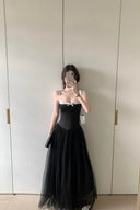 A woman takes a mirror selfie wearing a Vogsion Petite Structured Lace Corset Tulle Maxi Dress, standing in front of a light beige wardrobe door.