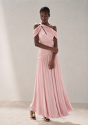 A model wearing Vogsion Signature Pleated Draped Shoulder Dress in Ivory/ Light Pink, standing against a neutral beige studio backdrop.