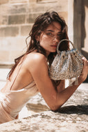 Woman holding VOGSION VS Beaded Bucket Bag luxury crystal evening purse in natural sunlight