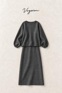 Charcoal grey wool-blend top and midi skirt flat lay on a textured ivory background with Vogsion wordmark