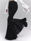 Black Gothic lace bell-bottom pants showing flared movement and sheer panels