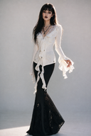 Black Gothic flare pants with floral lace panels and silver cross accents