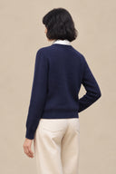 Back detail of Cavelle navy merino wool-blend sweater showing the plain knit and ribbed hem.