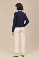 Full-length back view of Cavelle navy knit sweater with long sleeves and a ribbed hem.