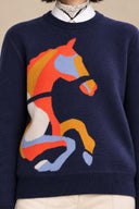 Close-up of the orange, gold, blue and ivory horse intarsia on Cavelle navy knit sweater.