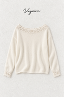 Ivory crochet-trim wool-blend sweater flat lay with Vogsion lettering on a pale stone background.