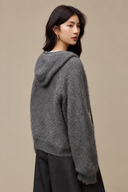 Three-quarter back view of the Grey hooded cardigan showing the hood, raglan sleeve and ribbed hem.