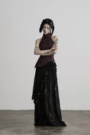 Full front view of the Noctara asymmetrical black lace maxi skirt with silver-tone charm details