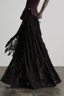 Side movement view of the Noctara black lace maxi skirt showing its flowing A-line silhouette