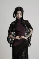 Front styling view of the Noctara black lace maxi skirt with a burgundy top and lace shawl, sold separately