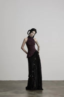 Three-quarter front view of the Noctara black layered lace maxi skirt with textured fringe and charms
