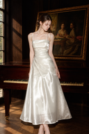 Isabeau ivory satin maxi dress with a ruched bodice, spaghetti straps and an A-line skirt, full-length front view.
