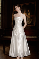 Three-quarter front view of the Isabeau ivory draped satin maxi dress with a fitted ruched waist and A-line skirt.