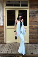Front full-length view of light blue two-piece skirt set with asymmetric layered top