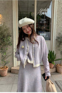 Petite woman wearing soft lilac wool-blend faux-layer cardigan and matching A-line knit skirt set