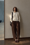 Ivory wool crewneck cardigan with dark neckline trim, front view