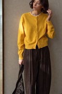 Yellow wool cardigan front detail with long sleeves and tonal buttons