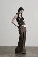 Side view of the dark brown serpent-embroidered wool knit halter top showing its fitted silhouette