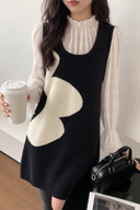 Close-up view of the navy and ivory wave knit mini dress