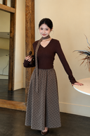Odette petite two-piece outfit with a long-sleeve chocolate top and taupe polka dot maxi skirt, styled beside a table.