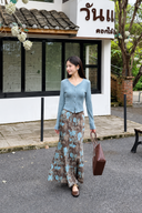 Petite model in a fitted light blue cardigan and brown floral maxi skirt