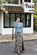 Petite model wearing a light blue cotton knit cardigan and floral maxi skirt