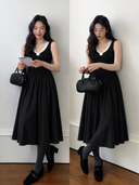 Two model views of a black cotton knit midi dress with ivory collar, small rosette and flowing A-line skirt.