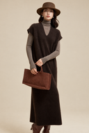 Front view of a brown V-neck knit dress with a relaxed straight silhouette and suede tote.