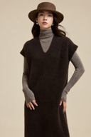 Brown V-neck knit dress with ribbed cap sleeves, styled over a taupe turtleneck, front detail.