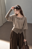Taupe cotton knit top showing the contrast fitted lower sleeves, beaded neckline and buttoned waist.