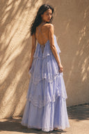Rear view of the Vogsion Seraphina Tiered Chantilly Lace Maxi Dress in lavender with lace-up open back, delicate spaghetti straps, tiered Chantilly lace details and elegant flowing skirt perfect for summer occasions.
