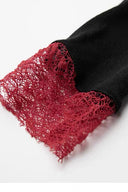 Close-up of the loose burgundy lace cuff joined to the soft black sleeve