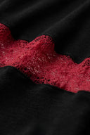 Close-up of vein-like burgundy openwork lace integrated with the black lyocell wool blend fabric
