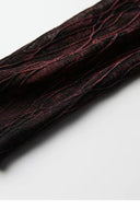 Close-up of the black and red mesh sleeve and textured surface