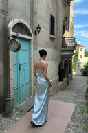 Back view of the VOGSION Alicia light blue petite maxi dress with delicate straps and a floor-length satin skirt