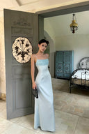 Model wearing the VOGSION Alicia light blue petite maxi dress with beaded fringe inside a Mediterranean villa